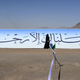 A Yemeni woman in charge of security stands at a Houthi gathering just outside Sana’a on January 24, 2013.